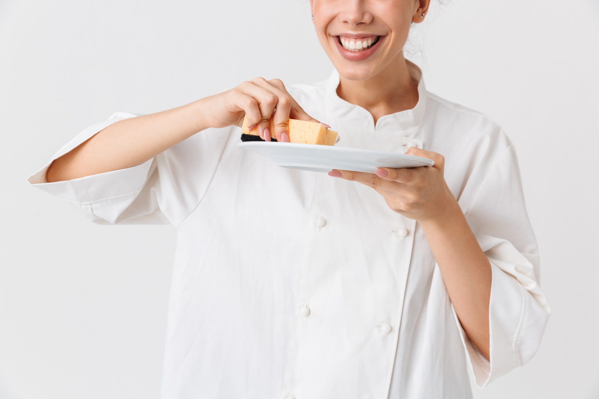 Consultant tasting dish with chef in a small kitchen
